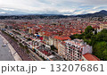 Aerial view of Nice city with red rooftops, promenade, and coastline along the Mediterranean Sea on a cloudy day. Scenic urban landscape of French Riviera. 132076861