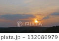 A calm landscape with clouds moving in the evening sky 132086979