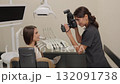 Dentist woman photographing with professional camera the result of her work in clinic 132091738