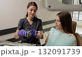 Dentist wearing rubber gloves holding transparent aligners for teeth correction for a patient in dentistry clinic 132091739