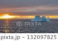 Stunning sunset over icy waters with floating icebergs in Antarctioca 132097825