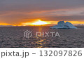 Stunning sunset over icy waters with floating icebergs in Antarctioca 132097826