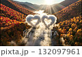 Aerial view of an autumn valley with animated clouds forming a heart shape. Romantic fantasy scene over a river and colorful forest. Love and nature concept 132097961