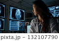 East Asian Female Cardiologist Analyzing Medical Scans in Modern Lab 132107790