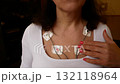 A woman with a holter on her body 132118964