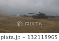 A tank in the field stands and shoots. Tank battle.  132118965
