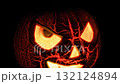 Glowing Halloween Pumpkin Waving on Black Background 132124894