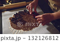 Prepare delicious homemade gingerbread cookies during the festive season. Close-up on hands using various cookie cutters to shape holiday treats from dough. Perfect for capturing the joy of Christmas 132126812