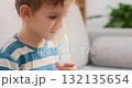Young Child Using Nebulizer for Respiratory Treatment at Home 132135654