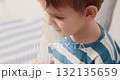 Young Child Using Nebulizer for Respiratory Treatment at Home 132135659