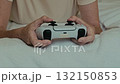 Young woman plays with video game controller 132150853