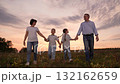 mother father children boy girl park sunset, man woman toddlers outdoors, Happy family walking in a field at sunset, Parents and children holding hands together, Family enjoying nature outdoors 132162659
