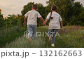 girl boy children run sunset, Happy children running in nature, kids holding hands in a field, childhood friendship outdoors, summer adventure for kids, siblings enjoying a walk, playful kids in 132162663