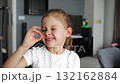 Smiling girl proudly shows her lost baby tooth, focus on joyful face. Celebration of childhood milestone and emotional development moment. 132162884