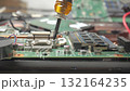 Close up technician hand repairing computer motherboard with screwdriver 132164235