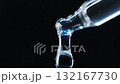An extreme macro close-up video of a glass pipette dispensing a clear, viscous liquid, likely a serum, hyaluronic acid, or essential oil, against a deep black background. 132167730