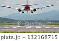 4K Back view of airplane touching down runway with smoke 132168715