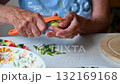Woman cutting and preparing vegetables at home in the kitchen. Concept for cooking and food preparation. 132169168