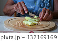 Woman cutting and preparing vegetables at home in the kitchen. Concept for cooking and food preparation. 132169169