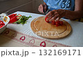 Woman cutting and preparing vegetables at home in the kitchen. Concept for cooking and food preparation. 132169171