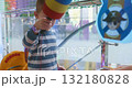 Child Playing Whack-a-Mole Game at Indoor Amusement Center 132180828
