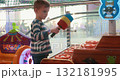 Child Playing Whack-a-Mole Game at Amusement Arcade 132181995