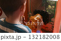 Child Playing with Arcade Game Machine in Indoor Entertainment Center 132182008