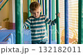 Child Playing in Indoor Playground with Colorful Structures 132182011