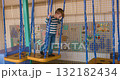 Child Playing on Indoor Playground Equipment at Activity Center 132182434