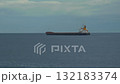 A bulk cargo carrier ship travels on a calm sea, cloudy sky 132183374