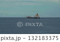 A bulk cargo carrier ship travels on a calm sea, cloudy sky 132183375