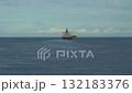 A bulk cargo carrier ship travels on a calm sea, cloudy sky 132183376