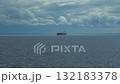 A heavy crude oil tanker traveling over calm sea near the coast of Orkney under cloudy sky 132183378
