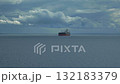 A heavy crude oil tanker traveling over calm sea near the coast of Orkney under cloudy sky 132183379