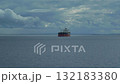 A heavy crude oil tanker traveling over calm sea near the coast of Orkney under cloudy sky 132183380