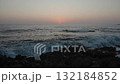 Sea waves crushing on a rocky beach at sunset 132184852