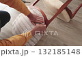 Anonymous person restore old vintage chair in home. Fabric replacement. Antique furniture and modern striped linen and cotton fabric. Hobbies, crafts, and retro-minimalist style. 132185148
