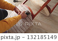 Anonymous person restore old vintage chair in home. Fabric replacement. Antique furniture and modern striped linen and cotton fabric. Hobbies, crafts, and retro-minimalist style. 132185149