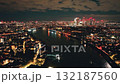 England, London: Canary Wharf skyscrapers reflecting on River Thames at night, aerial view of London urban cityscape with colorful illuminated buildings under dark cloudy sky. Drone flight footage England, London: Canary Wharf skyscrapers reflecting on River Thames at night, aerial view of London urban cityscape with colorful illuminated buildings under dark cloudy sky. Drone flight footage 132187560