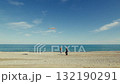 Father and son playing with kite near the ocean on the beach for the day 132190291