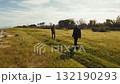 Men playing soccer in an outdoor grassy park in spring 132190293