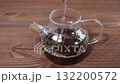 Hot water pouring in the glass teapot with black tea. 132200572