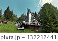 Stylish A-frame cabin with full-height panoramic windows and hot tub nestled on a grassy slope in the mountains 132212441