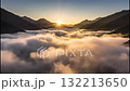 Time-lapse of a spectacular sunrise over a mountain valley filled with clouds. The morning fog clears to reveal a lush green landscape with a river. Majestic aerial view of nature's beauty Time-lapse of a spectacular sunrise over a mountain valley filled with clouds. The morning fog clears to reveal a lush green landscape with a river. Majestic aerial view of nature's beauty 132213650