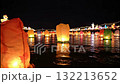 Colorful floating lanterns on water at a night festival. Vertical video of glowing paper lights reflecting on a river during a celebration Colorful floating lanterns on water at a night festival. Vertical video of glowing paper lights reflecting on a river during a celebration 132213652