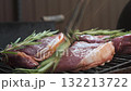 Raw beef steak with rosemary grilling on barbecue 132213722