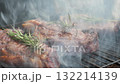 Juicy grilled beef steak with herbs and smoke rising 132214139