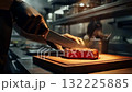 A Culinary Masterclass: Expertly Slicing a Perfectly Cooked Steak in a Professional Kitchen Setting with Culinary Precision and Artistic Flair. 132225885