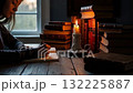 A Tranquil Evening of Reflection and Writing by Candlelight in an Atmosphere Surrounded by Abundant Literature and Cozy Ambiance. 132225887