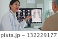Young Asia female doctor with old man patient use clipboard for consulting, advice and medical expert at desk in health clinic office. Help, appointment support in hospital for diagnosis, physician. 132229177